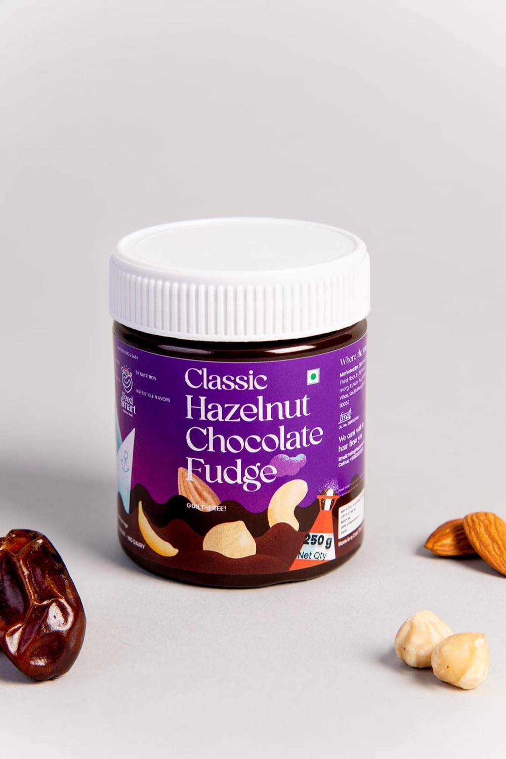 Feed Smart Classic Hazelnut Chocolate Fudge jar, styled with dates, almonds and hazelnuts