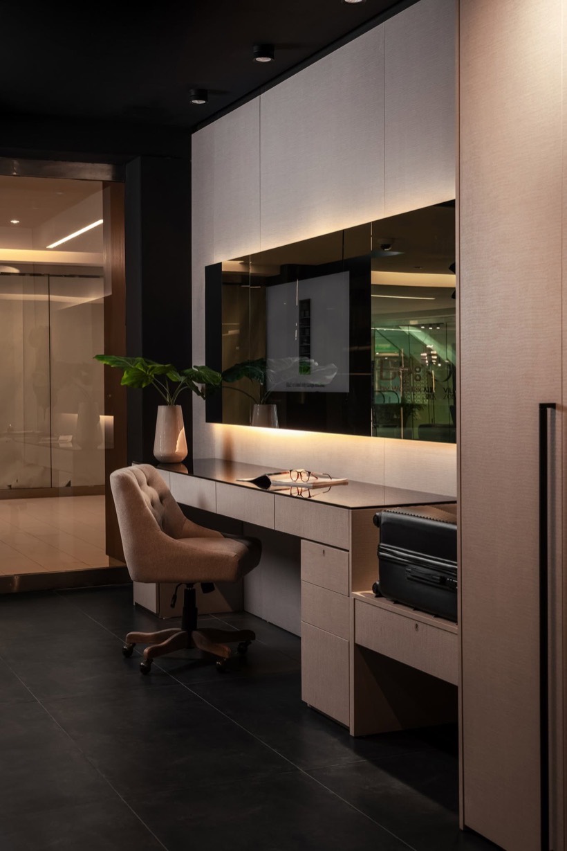 Woodex showroom desk nook with an upholstered chair, mirror and concealed storage